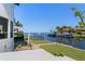 Backyard area with a patio, grass area, and access to a private boat dock and canal at 8 Ocean Dr, Punta Gorda, FL 33950
