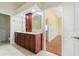Bathroom with dark wood vanity, double sinks, and tile flooring at 8 Ocean Dr, Punta Gorda, FL 33950