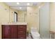 Cozy bathroom features neutral tiling, cherry vanity, and a glass-enclosed shower at 8 Ocean Dr, Punta Gorda, FL 33950