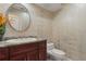 Charming powder room featuring stylish vanity with granite countertop and decorative mirror at 8 Ocean Dr, Punta Gorda, FL 33950