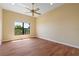 Bedroom with hardwood floors, a ceiling fan, and a bright window at 8 Ocean Dr, Punta Gorda, FL 33950