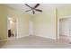 Bright bedroom with neutral decor and tiled floors leading into an ensuite bathroom at 8 Ocean Dr, Punta Gorda, FL 33950