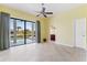 Airy bedroom with a sliding glass door, neutral decor, and easy access to the pool at 8 Ocean Dr, Punta Gorda, FL 33950