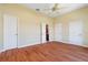 An empty bedroom with three doors and wood flooring at 8 Ocean Dr, Punta Gorda, FL 33950
