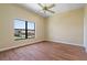 This bedroom has a ceiling fan and window offering a view of the outdoors at 8 Ocean Dr, Punta Gorda, FL 33950