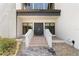 Close-up of the home's front entrance, showcasing the double doors, brick steps, and well-maintained landscaping at 8 Ocean Dr, Punta Gorda, FL 33950