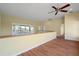 Second floor hallway with hard wood floors, a ceiling fan, and decorative window at 8 Ocean Dr, Punta Gorda, FL 33950
