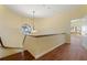 Second floor hallway with a round window, wood floors, and chandelier at 8 Ocean Dr, Punta Gorda, FL 33950