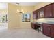 Bright kitchen nook with custom cherry cabinets, built in desk, modern lighting, and large window at 8 Ocean Dr, Punta Gorda, FL 33950