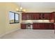 Bright kitchen features custom cherry cabinets, modern lighting, stone countertops, and views of the water at 8 Ocean Dr, Punta Gorda, FL 33950