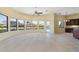 Open living room with a gorgeous wall of windows showcasing water views and pool access at 8 Ocean Dr, Punta Gorda, FL 33950