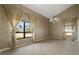 Spacious living room with a large window offering views of the lush, tropical landscape at 8 Ocean Dr, Punta Gorda, FL 33950