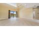 Spacious living area with tile flooring, large sliding glass doors leading to the outside, and high ceilings at 8 Ocean Dr, Punta Gorda, FL 33950