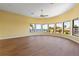 Open living room with hard wood floors and floor-to-ceiling windows showing canal views at 8 Ocean Dr, Punta Gorda, FL 33950