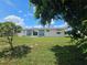 The backyard features mature mango trees and a sliding glass door at 858 Conreid Ne Dr, Port Charlotte, FL 33952