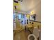 Retro bathroom with yellow tiles, matching fixtures, and a black-and-yellow shower curtain at 858 Conreid Ne Dr, Port Charlotte, FL 33952