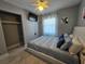 Comfortable bedroom featuring ceiling fan, television, and a closet for ample storage at 858 Conreid Ne Dr, Port Charlotte, FL 33952