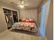 Bright bedroom with open closet, comfortable bed, and window with vertical blinds at 858 Conreid Ne Dr, Port Charlotte, FL 33952
