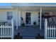 Cozy front porch showcasing a cozy swing, plants, and a welcoming entrance to the home at 858 Conreid Ne Dr, Port Charlotte, FL 33952