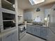 Functional kitchen featuring blue cabinetry, modern appliances, and a cozy atmosphere, ideal for home cooking at 858 Conreid Ne Dr, Port Charlotte, FL 33952