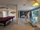 Open-concept living room with a game table and dining area, perfect for entertaining and Gathering gatherings at 858 Conreid Ne Dr, Port Charlotte, FL 33952