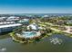 Aerial view of a large pool and lounge area surrounded by mature landscaping and a pond at 10300 Tarpon Landings Ter # 4, Placida, FL 33946