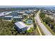 An aerial view showcasing a meticulously maintained tennis court and beautifully landscaped condos near scenic waterfront at 10300 Tarpon Landings Ter # 4, Placida, FL 33946