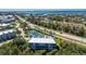This aerial showcases a lovely condo with a tennis court, emphasizing the coastal lifestyle and amenities at 10300 Tarpon Landings Ter # 4, Placida, FL 33946