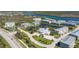 Aerial view of the condo community with a pool and water views; tennis and pickleball courts are shown at 10300 Tarpon Landings Ter # 4, Placida, FL 33946