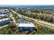 A high-angle view captures an attractive condo, perfectly situated among trees and local amenities in a coastal community at 10300 Tarpon Landings Ter # 4, Placida, FL 33946