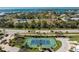 Aerial view showcases a tennis court near a road, nestled within a beautiful Florida community at 10300 Tarpon Landings Ter # 4, Placida, FL 33946