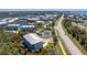 An aerial view of a beautiful condo with a view of a tennis court and lush surroundings in a desirable coastal community at 10300 Tarpon Landings Ter # 4, Placida, FL 33946