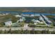 Beautiful condo community aerial with lake views, surrounded by natural beauty; tennis and pickleball courts are featured at 10300 Tarpon Landings Ter # 4, Placida, FL 33946