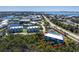 An aerial view of a stunning condo surrounded by tropical greenery and close to a tennis court at 10300 Tarpon Landings Ter # 4, Placida, FL 33946