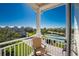 Scenic balcony view overlooking lush landscaping and tennis court at 10300 Tarpon Landings Ter # 4, Placida, FL 33946