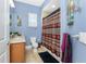 Cozy bathroom featuring blue walls, granite countertop, and tiled floor with a shower and decorative accents at 10300 Tarpon Landings Ter # 4, Placida, FL 33946