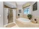 Relaxing bathroom featuring a soaking tub, shower and window to allow for natural light at 10300 Tarpon Landings Ter # 4, Placida, FL 33946
