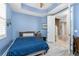 Bright bedroom with tray ceilings and warm blue walls at 10300 Tarpon Landings Ter # 4, Placida, FL 33946