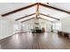 A spacious clubhouse interior featuring high vaulted ceilings, wooden beams, and a cozy fireplace feature at 10300 Tarpon Landings Ter # 4, Placida, FL 33946