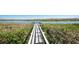 Community dock surrounded by mangroves offering access to the water and beautiful nature views at 10300 Tarpon Landings Ter # 4, Placida, FL 33946