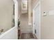 Hallway with a carpeted staircase and a door leading to a basement at 10300 Tarpon Landings Ter # 4, Placida, FL 33946