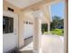 Exterior view of the home's front door, driveway, and a two-car garage at 10300 Tarpon Landings Ter # 4, Placida, FL 33946