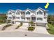 Beautiful multi-level townhouses with light exteriors, multiple balconies, and garages at 10300 Tarpon Landings Ter # 4, Placida, FL 33946
