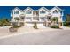Charming townhomes with individual garages, balconies, and well-maintained landscaping, offering a welcoming curb appeal at 10300 Tarpon Landings Ter # 4, Placida, FL 33946