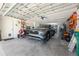 View of a well-organized garage with a parked SUV, tools, and storage solutions at 10300 Tarpon Landings Ter # 4, Placida, FL 33946