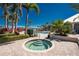 Hot tub with clear water and surrounding tropical landscaping, next to the community pool at 10300 Tarpon Landings Ter # 4, Placida, FL 33946