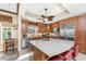 Bright kitchen with wood cabinets, tile floors, stainless steel appliances, and center island with seating at 10300 Tarpon Landings Ter # 4, Placida, FL 33946