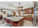 Open kitchen with wood cabinets, stainless steel appliances, granite countertops, and center island with seating at 10300 Tarpon Landings Ter # 4, Placida, FL 33946