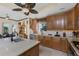 Well-lit kitchen with granite countertops, stainless steel appliances, wood cabinets, and tile floors at 10300 Tarpon Landings Ter # 4, Placida, FL 33946