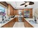 Traditional kitchen featuring granite countertops, stainless steel appliances, wood cabinets, and tile floors at 10300 Tarpon Landings Ter # 4, Placida, FL 33946